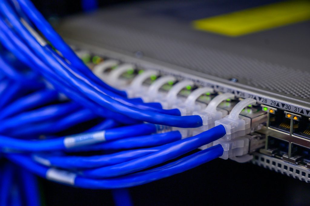pexels photo 2881232 2881232 Detailed view of blue ethernet cables connected to a network switch in a data center.