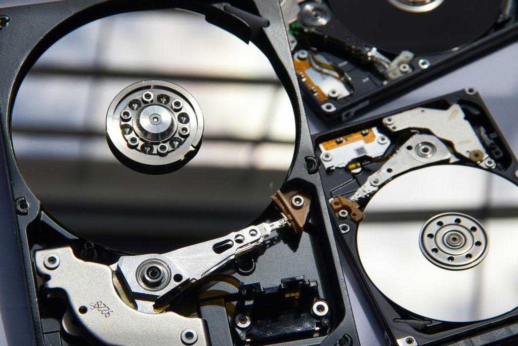pexels photo 6310146 6310146 Detailed view of disassembled hard drives showcasing technology and hardware components.